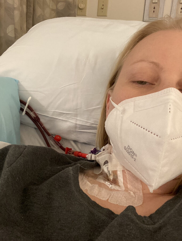 Dara lying down with a face mask on in the hospital