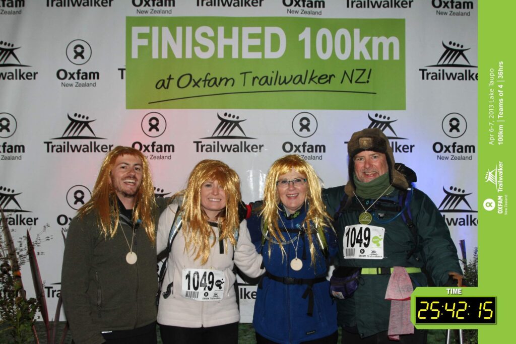 Amanda with friends finishing a 100km race. They are all wearing blonde long-haired wigs