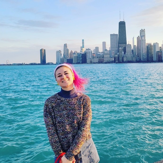 Danielle Silverman smiling in front of the water with the cityscape in the background