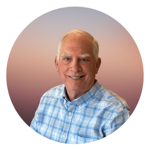 Steve Salky shown smiling with white hair and wearing a blue and white checkered shirt.