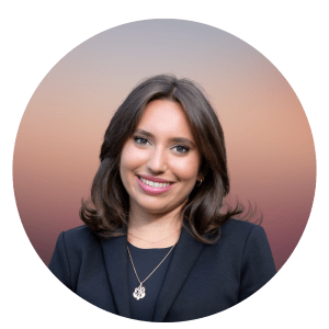 Elana Kane is smiling. She has dark hair and is wearing a black top with a semi-long pendant.