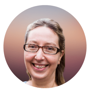 Barbara Willekens is shown with light hair and dark glasses. She is smiling.