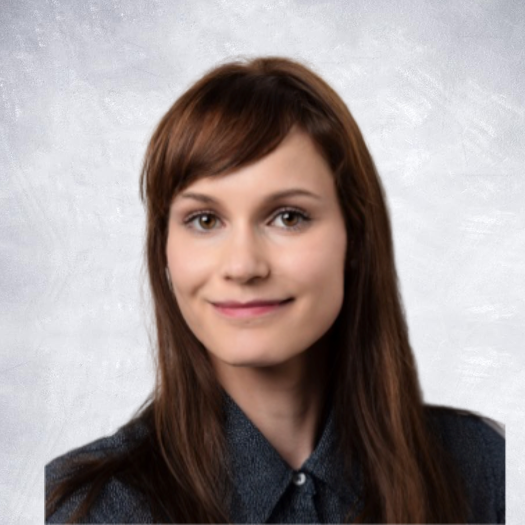 Nadine Strempel is shown with dark hair and smiling