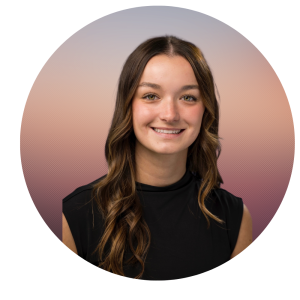 A young woman with long, wavy brown hair and a black sleeveless top smiles at the camera. The background is a soft gradient of pink, purple, and beige, reflecting the warm spirit of About The MOG Project.